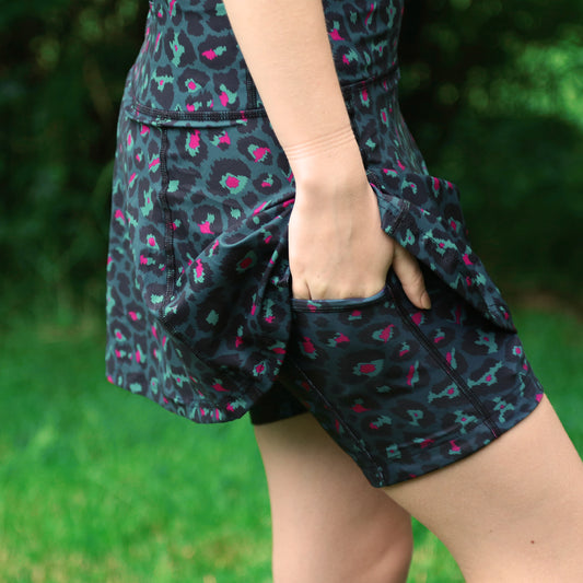 KOKO+KIND PANTHER SKORT. A leopard print skort in teal, black, aqua and pink, great for running, tennis and adventure.