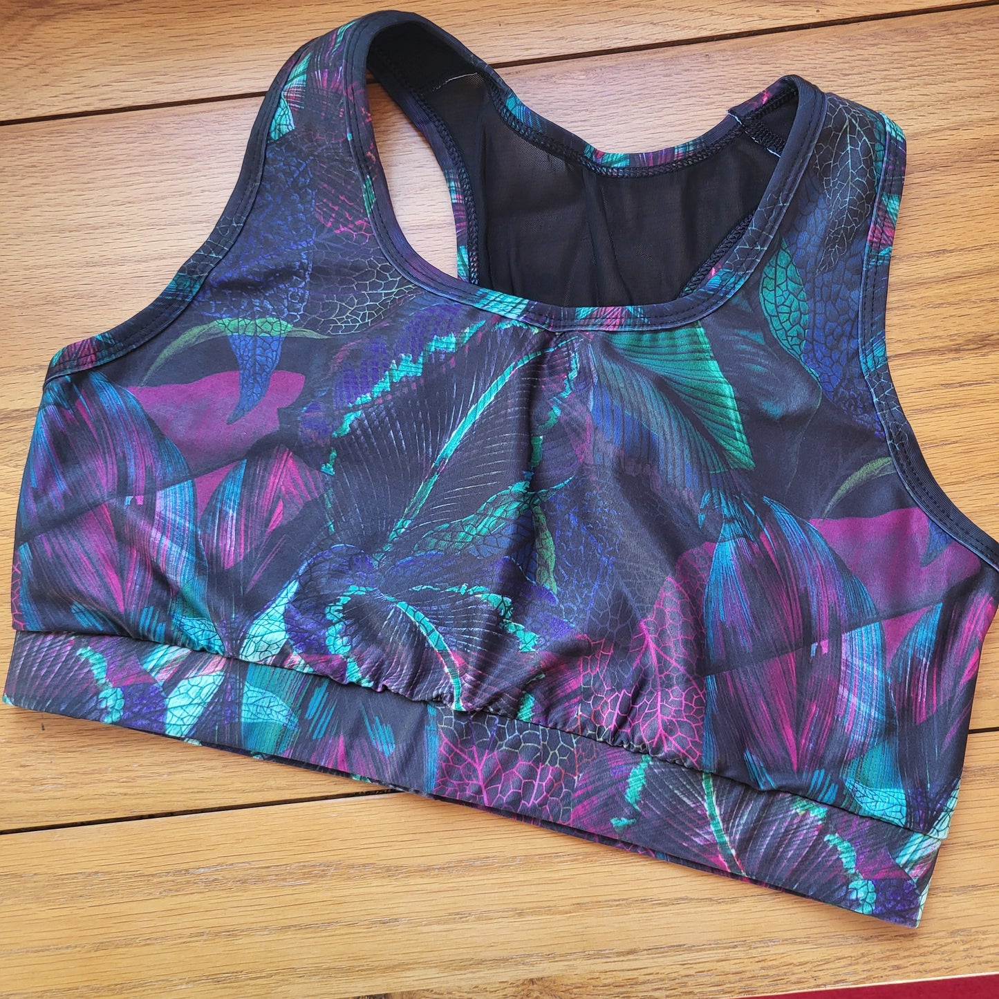 Multicolored swimsuit with abstract pattern on a wooden surface